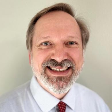 A person smiling for the camera AI-generated content may be incorrect.